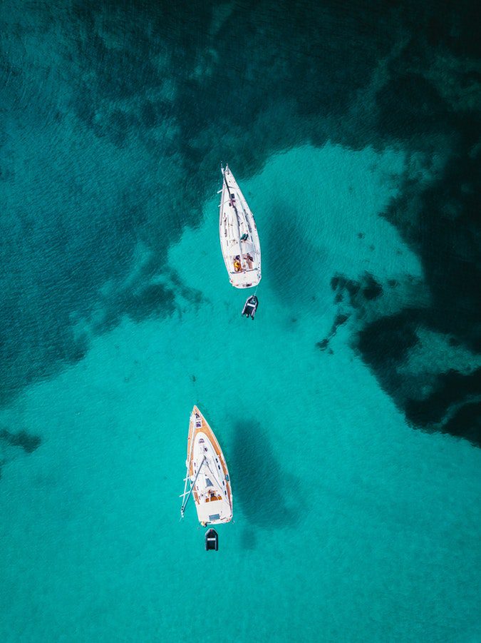 two sailboats in the ocean