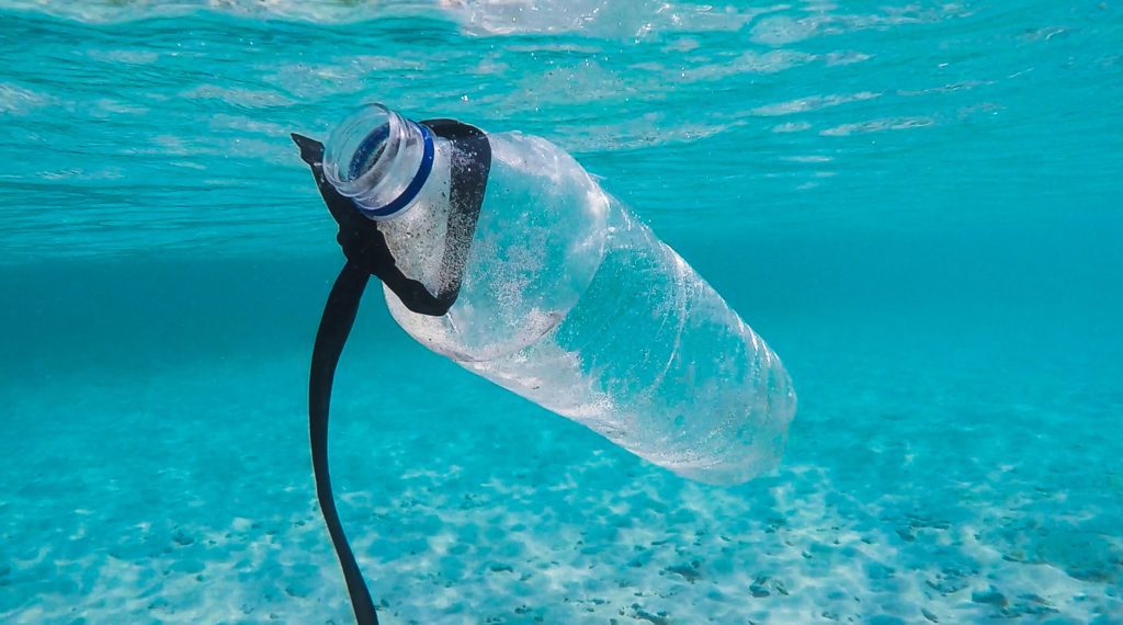 plastic bottle in blue ocean