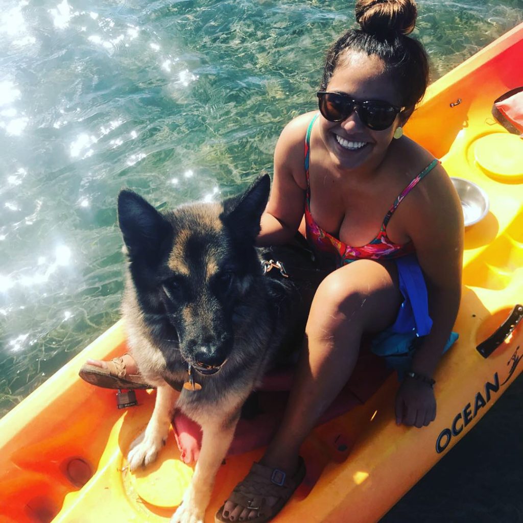 woman on kayak with dog