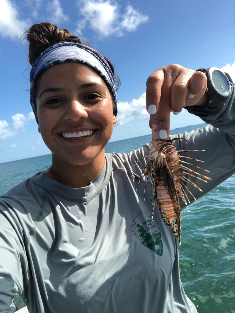 woman with lionfish on boat