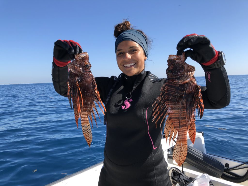 woman on boat with lionfish