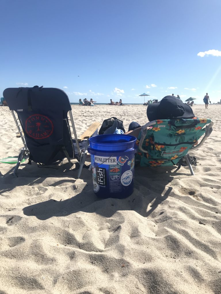 beach chairs with trash bucket on beach