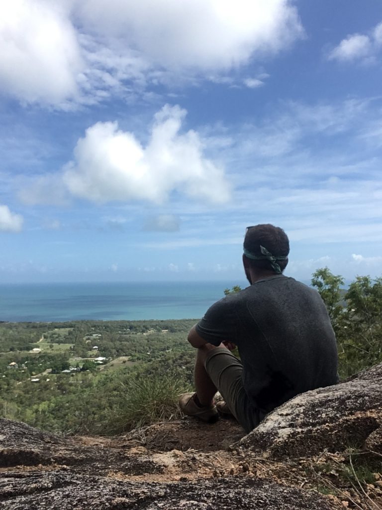 man looking over ocean on magnetic island australia