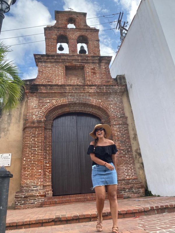 woman in dominican republic outside a church