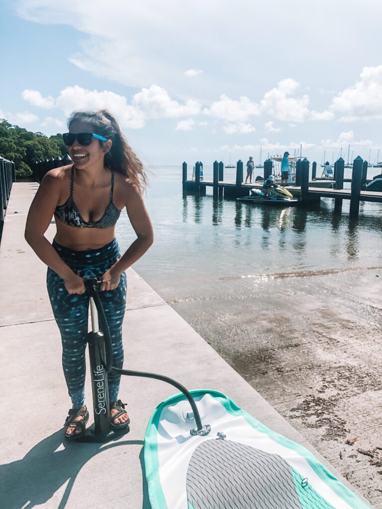 woman pumping paddleboard at crandon marina key biscayne