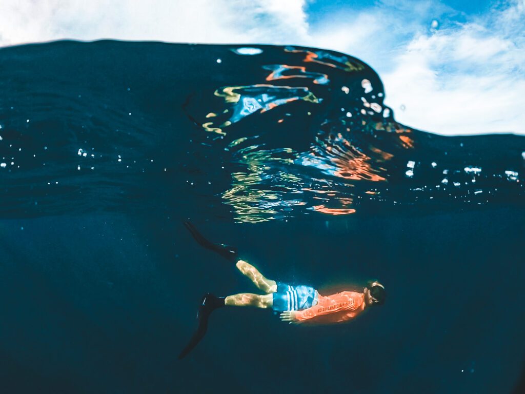 snorkeler underwater with sky