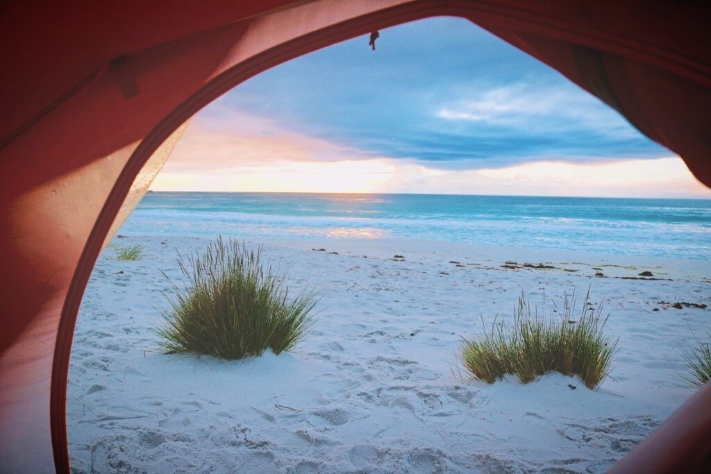 beach camping in a tent blue water