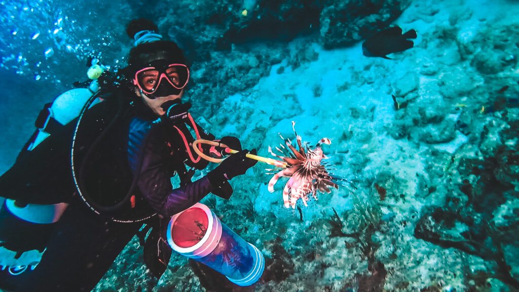 woman with lionfish on dive in deerfield beach