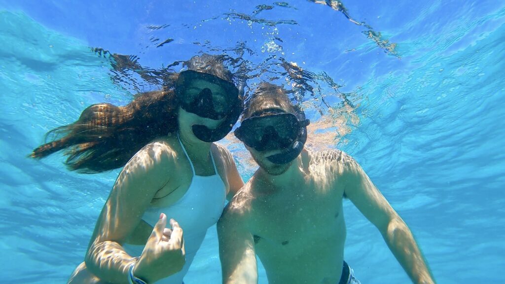 man and woman snorkeling in blue water punta cana dominican republic