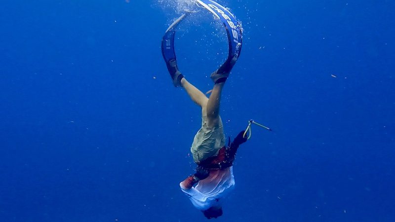 man freediving down on shallow coral reef st thomas usvi
