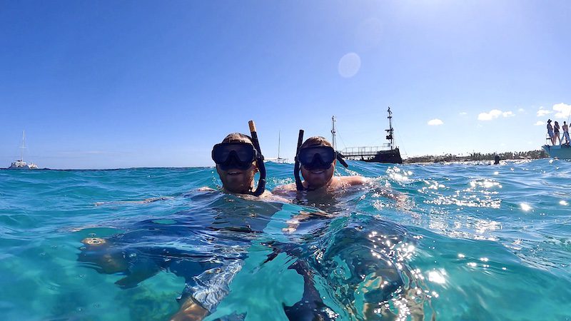 two men snorkeling in blue water in punta cana dominica republic