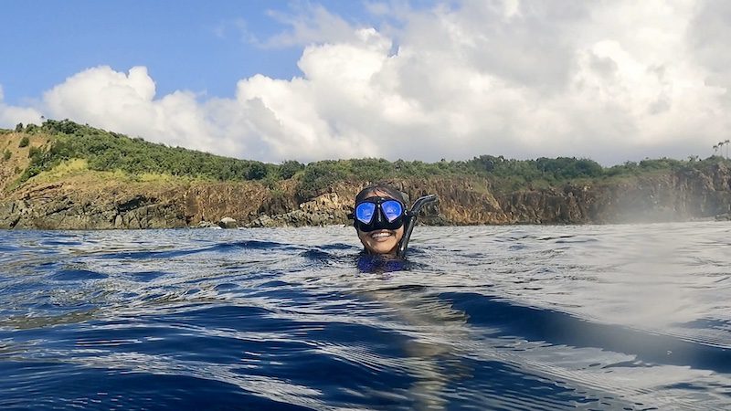 woman smiling in water while freediving west end of st thomas