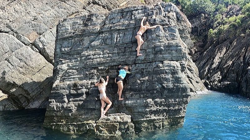 women climbing a rock to cliff jump in st thomas usvi