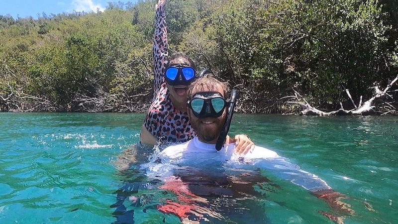man and woman snorkeling on the surface of the mangroves in hurricane hole