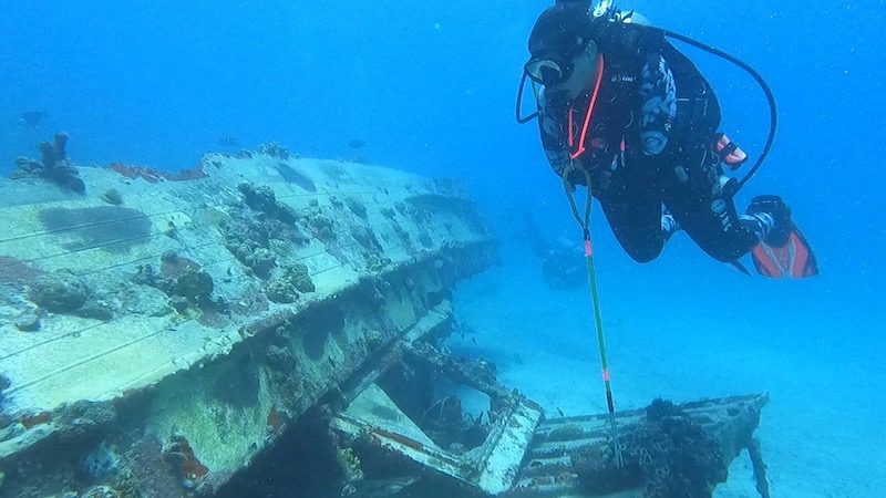 woman scuba diving on small shipwreck near thatch cay st thomas usvi