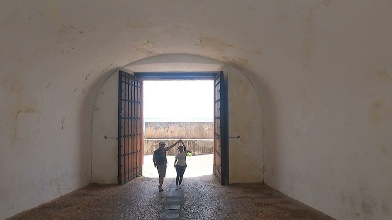 man and woman entering gateway of old san juan puerto rico