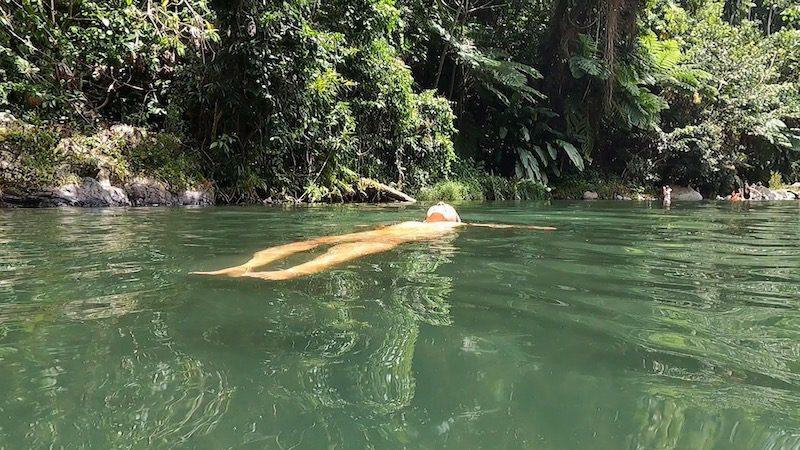 woman floating in las damas pool el yunque puerto rico