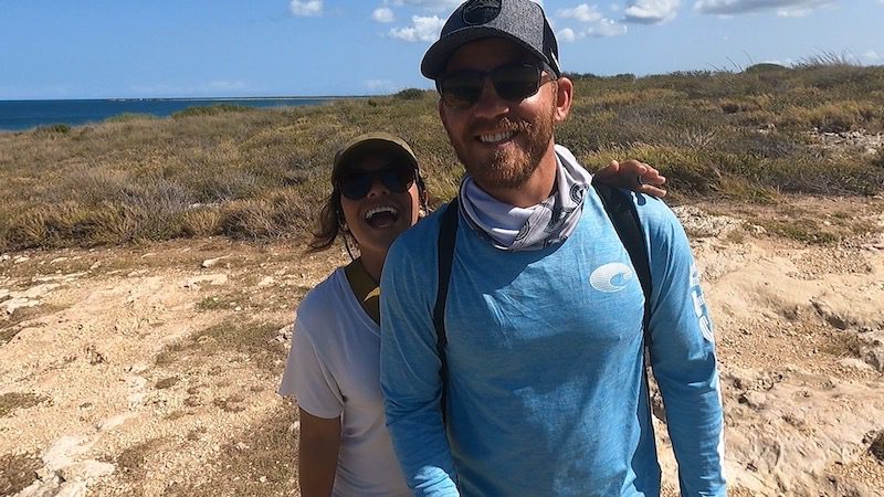 man and woman smiling while hiking cabo rojo faro los morrillos