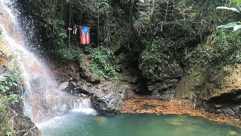 view of swimming pool and puerto rican flag charco el pilon hiking trail